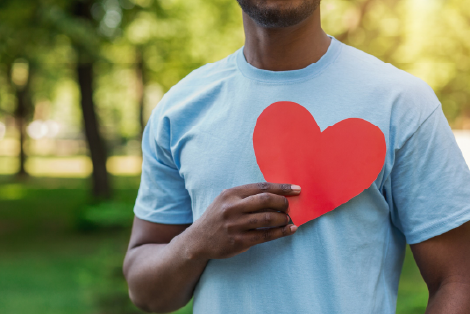 A man holding a paper heart