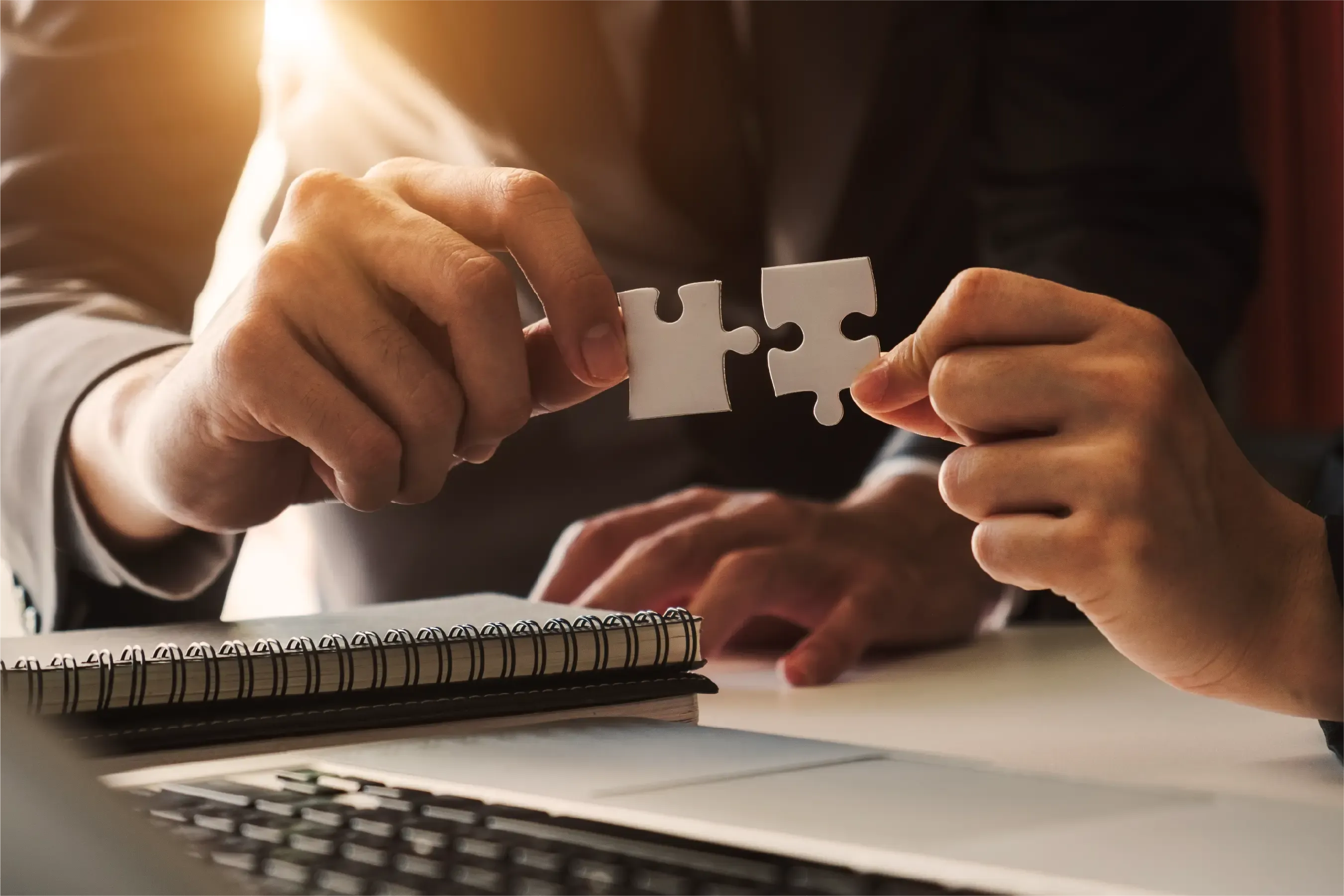 A person putting together two puzzle pieces